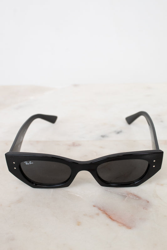 Black sunglasses on a marble surface