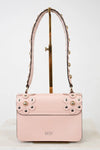 Pink handbag with gold studs on a white background