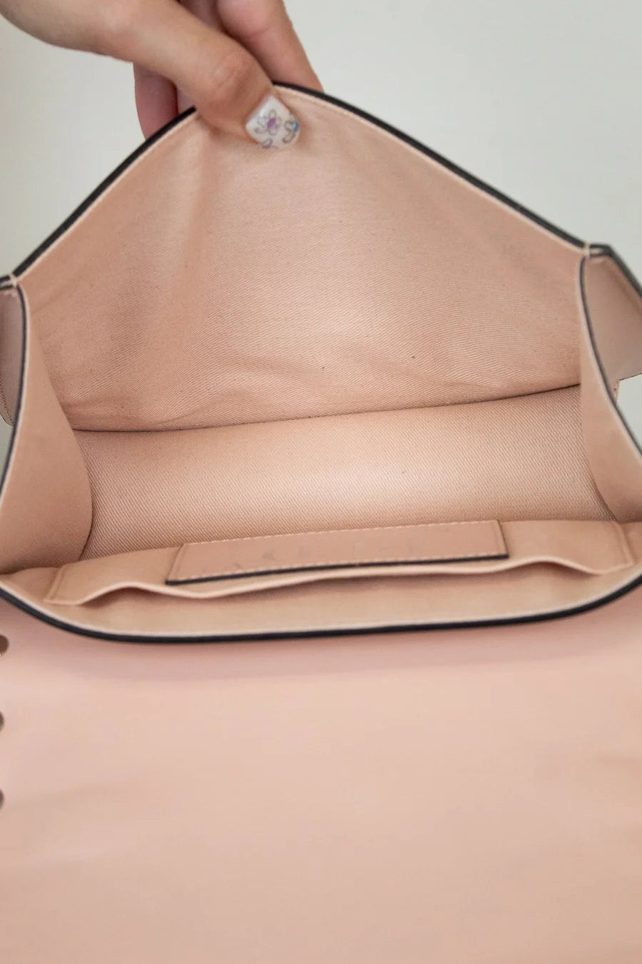 Close-up of bag with a hand holding it open.