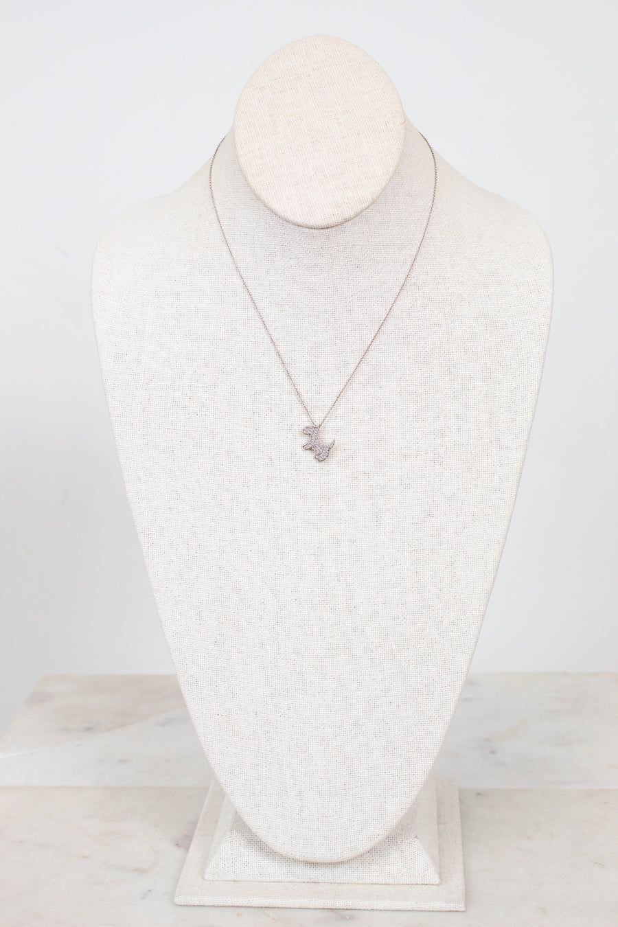 Necklace displayed on a mannequin bust against a white background