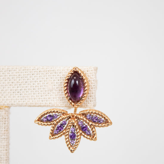 Leaf shaped gold and purple earring on white background