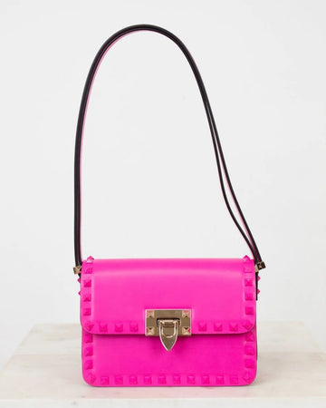 Pink handbag with a gold clasp on a white background