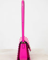 Pink handbag with a strap on a white background