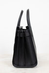 A black pebbled leather handbag shown from a side profile view, featuring dual top handles and a structured rectangular silhouette, set against a clean white background.