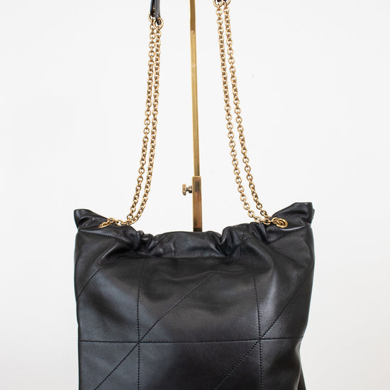 A black leather slouchy shoulder bag with a gold-tone chain strap, displayed on a white studio background.