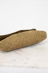 Brown textured bag on a white marble surface