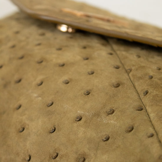 Close-up of a brown handbag with a textured surface.