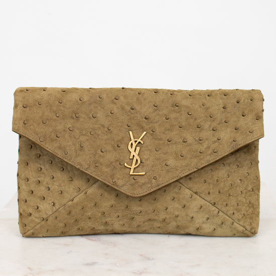 Beige clutch bag with a "YSL" brand logo on a white background