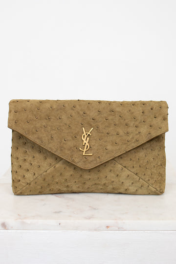 Beige clutch bag with a "YSL" brand logo on a white background
