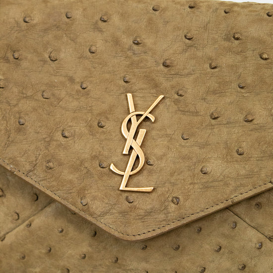 Beige handbag with a gold "YSL" logo on a light background