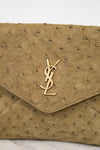 Beige handbag with a gold "YSL" logo on a light background