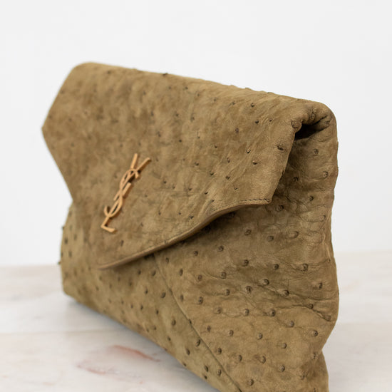 Brown clutch bag with a brand logo on a white surface