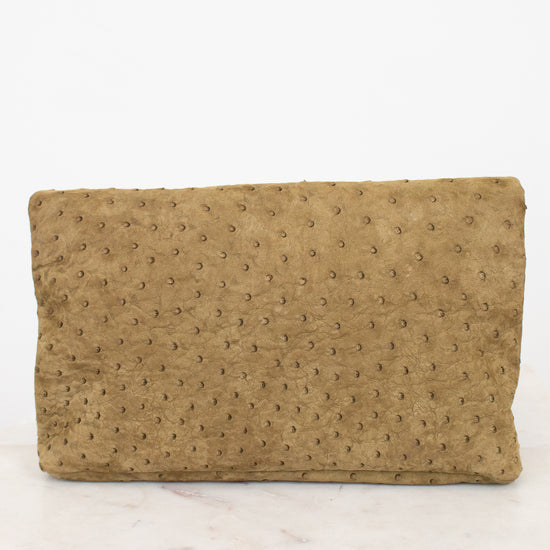 Brown textured clutch bag on a white marble surface