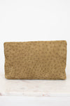 Brown textured clutch bag on a white marble surface
