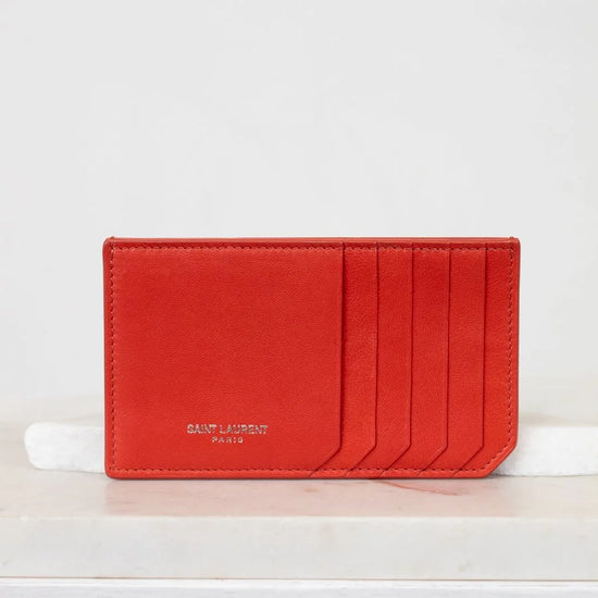 Red cardholder with 'Saint Laurent' branding on a white background