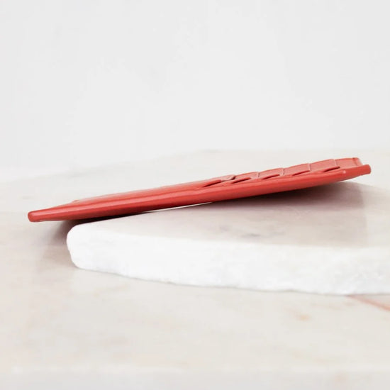 Red card holder white surface with a light gray background