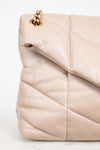 Beige quilted handbag with gold chain detail on a white background