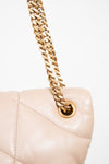 Beige handbag with gold chain on a white background