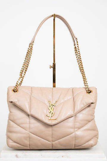 Beige handbag with gold chain strap on a white background
