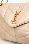 Beige handbag with a gold logo on a light background