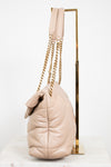 Beige handbag with gold chain on a white background