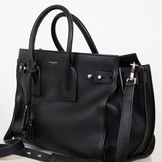 Black leather handbag on a white background