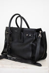 Black leather handbag on a white background