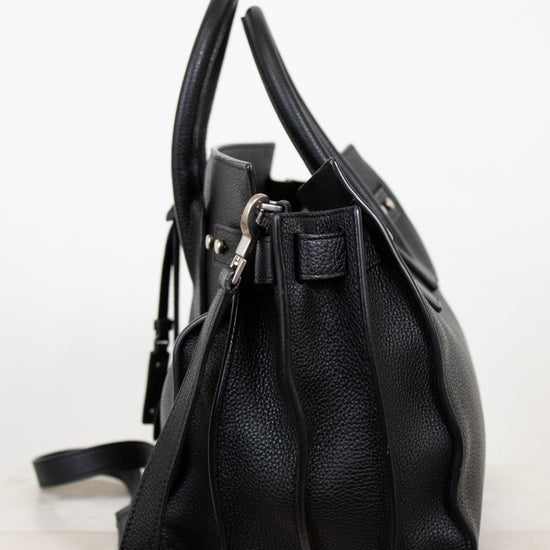 Black leather handbag on a white background
