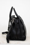 Black leather handbag on a white background