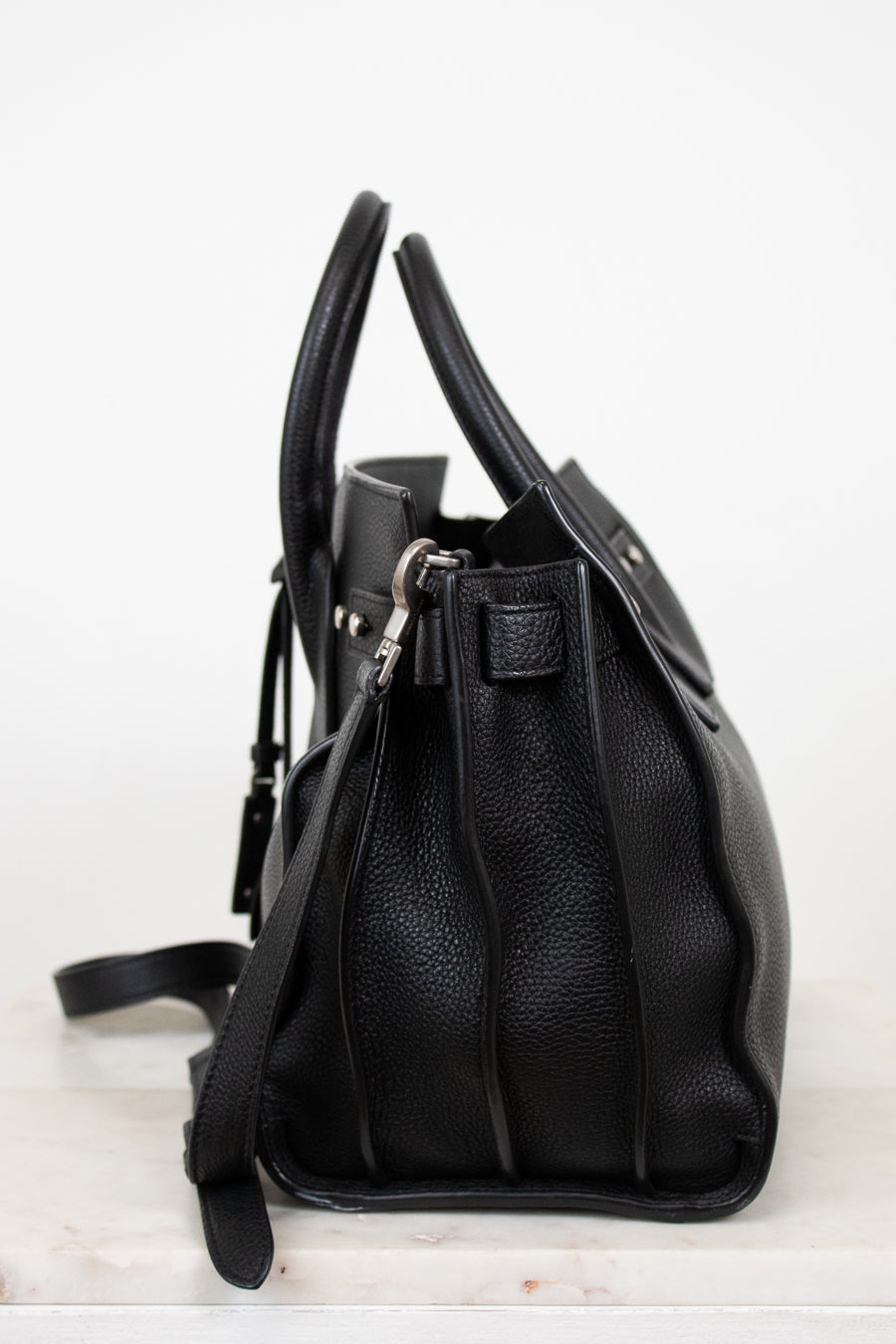 Black leather handbag on a white background