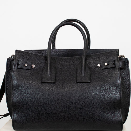 Black leather handbag on a white background