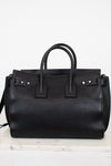 Black leather handbag on a white background