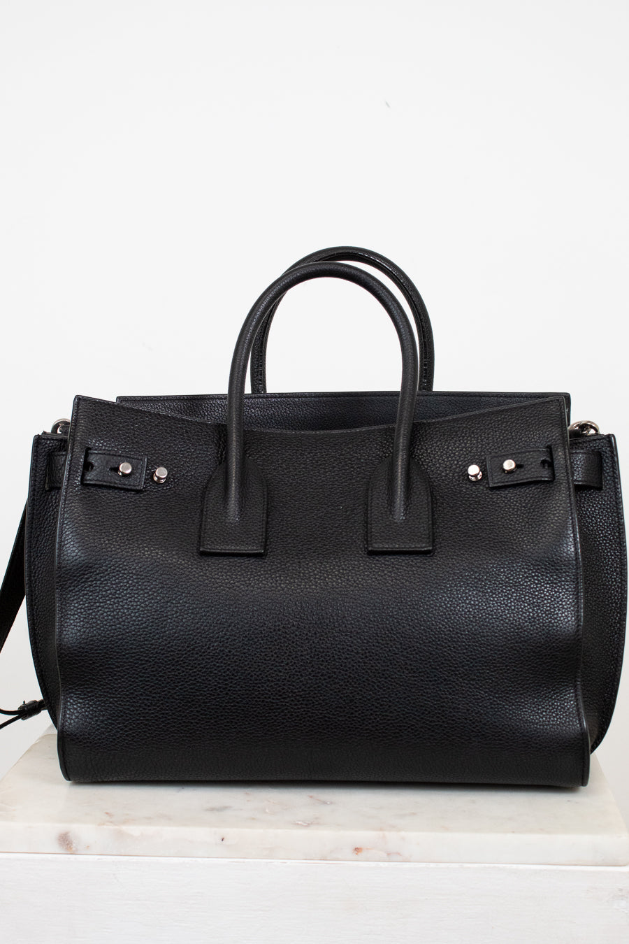 Black leather handbag on a white background