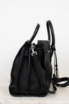 Black leather handbag on a light gray background