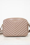 Beige quilted handbag on a white background