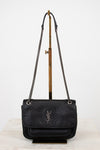 Black handbag with chain strap on a white background
