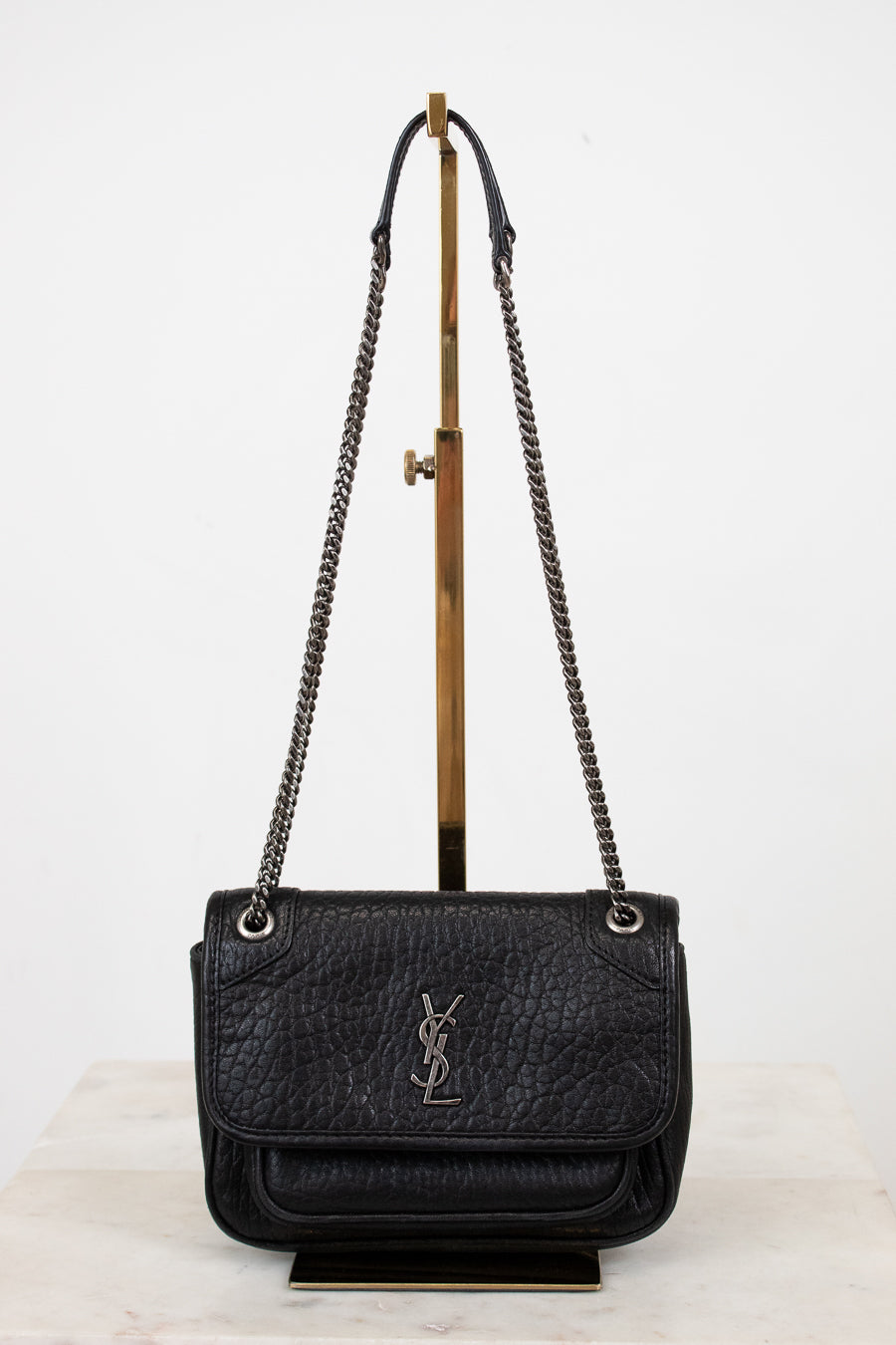 Black handbag with chain strap on a white background