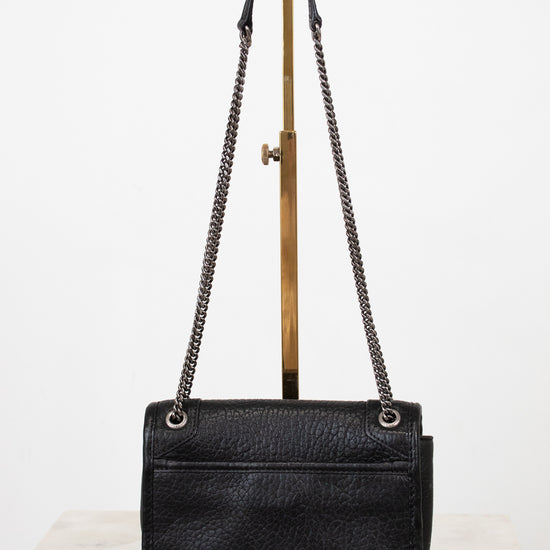 Black handbag with chain strap on a white background