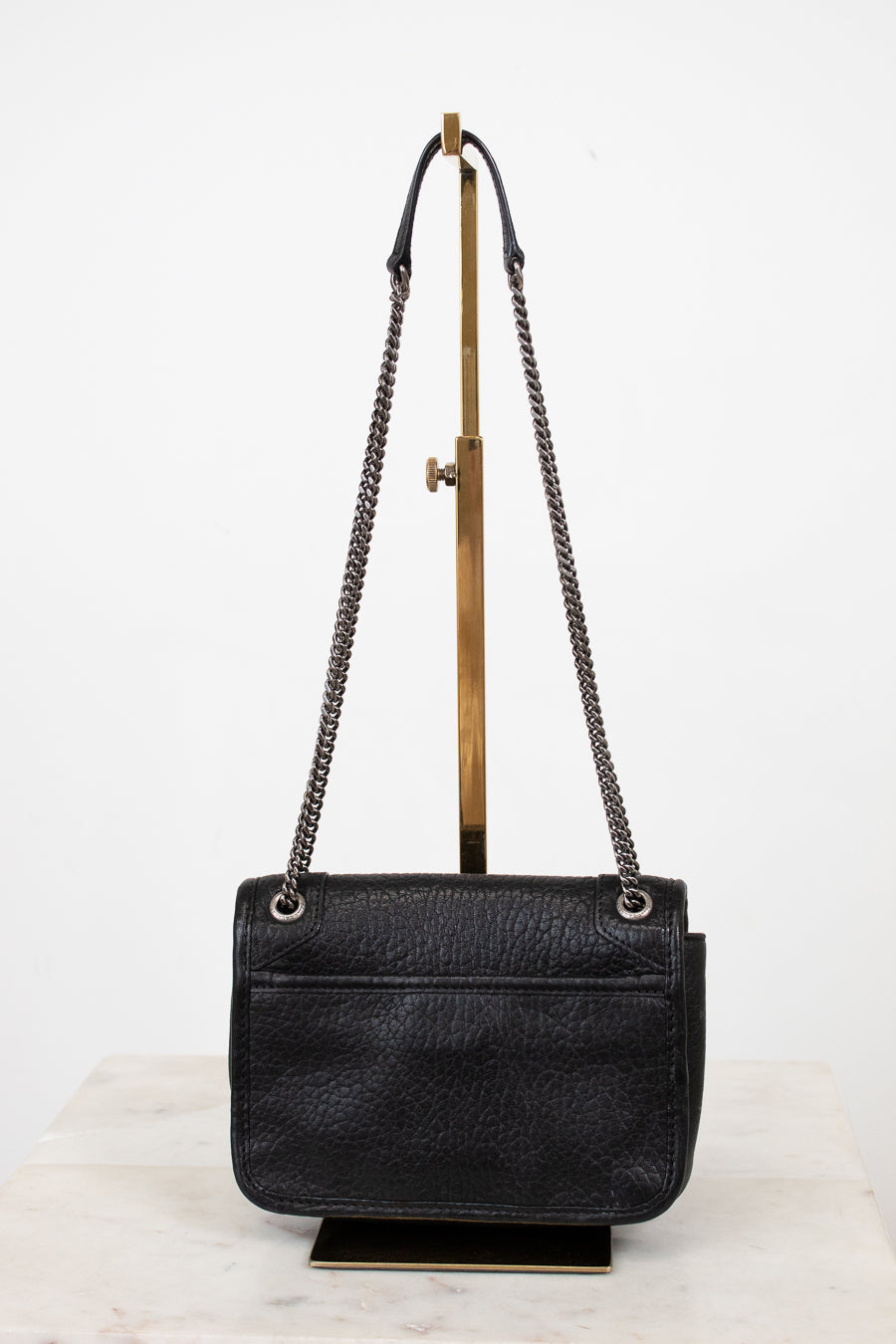 Black handbag with chain strap on a white background