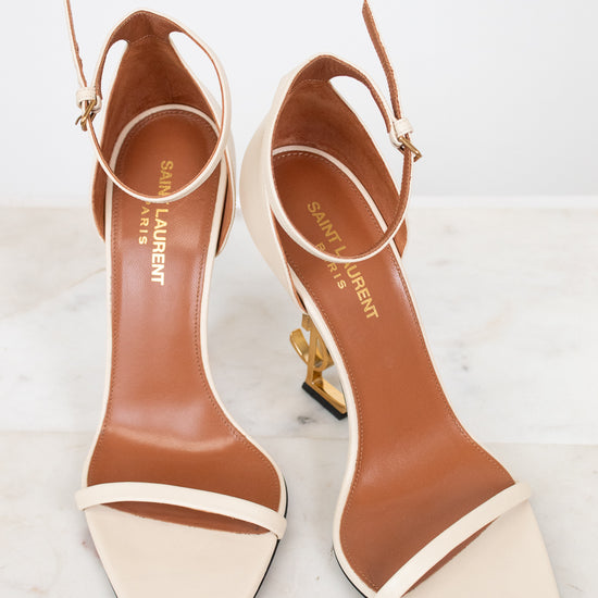 Pair of YSL high-heeled sandals on a light background