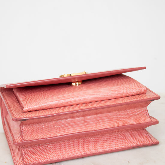 Bottom view of pink lizard leather bag with gold-tone hardware