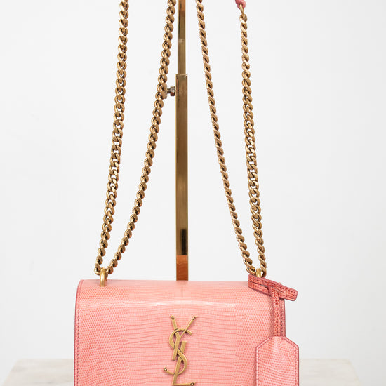 Pink lizard leather bag with gold chain straps and 'YSL' logo