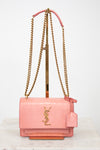 Pink lizard leather bag with gold chain straps and 'YSL' logo