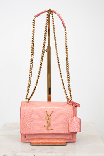 Pink lizard leather bag with gold chain straps and 'YSL' logo