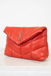 Red quilted handbag with a brand logo on a light background