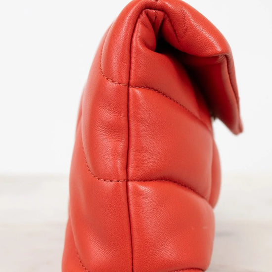 Red leather handbag on a white background