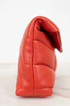 Red leather handbag on a white background