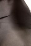 Close-up of a dark gray fabric texture of handbags interior 