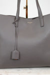 Gray handbag with a visible "Saint Laurent" brand logo on a light background