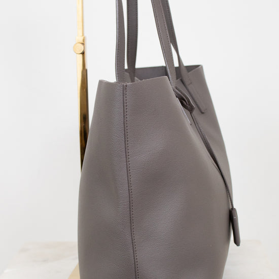 Gray leather tote bag on a white background